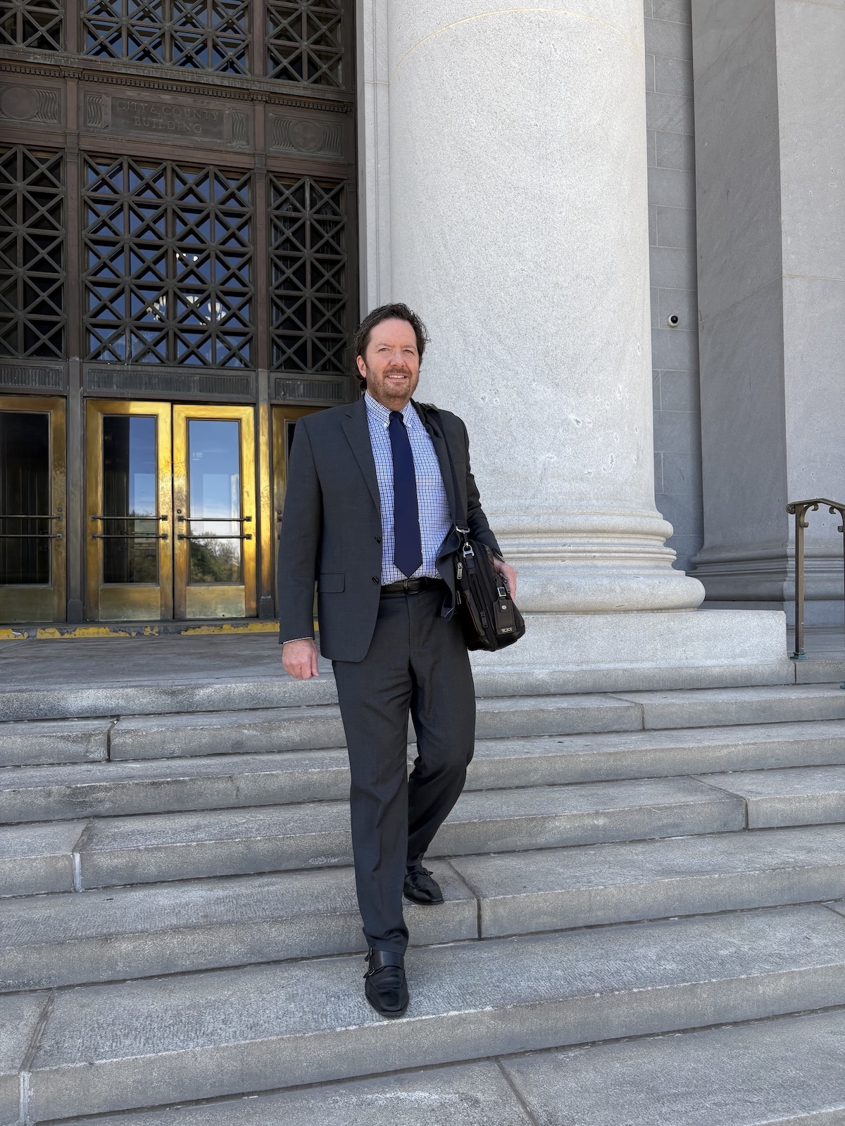 Attorney Monte J. Robbins leaving the Denver City and County Building after a court appearance.